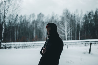 Man standing on snow covered field