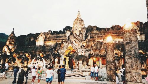 People at temple against clear sky