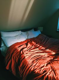 High angle view of messy bed at home