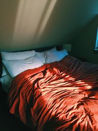 High angle view of messy bed at home