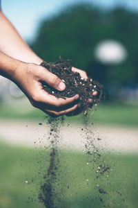 Cropped hand holding soil