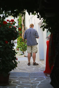 Rear view of man standing on footpath