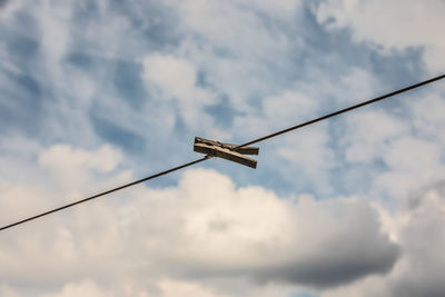 Low angle view of telephone pole against sky