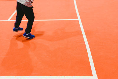 Low section of man playing on court