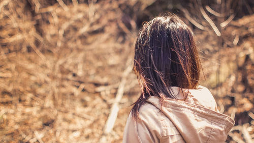 Rear view of woman on field