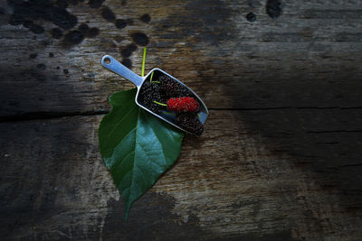 Close-up of strawberry on table against wall