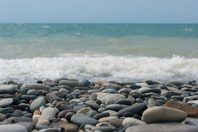 View of pebbles on beach against sky