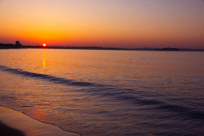 Scenic view of sea against romantic sky at sunset