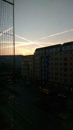 Buildings in city at sunset