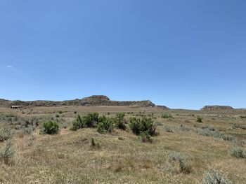 Scenic view of land against clear blue sky