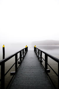 Pier over sea against sky