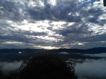 Scenic view of mountains against cloudy sky