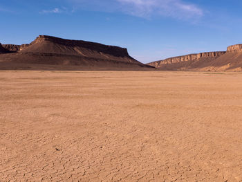 Scenic view of arid landscape against sky