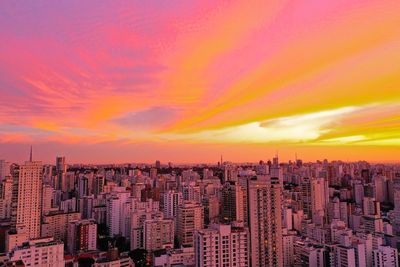 High angle view of modern buildings against sky during sunset