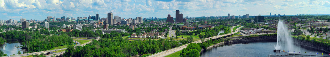Panoramic view of city against cloudy sky