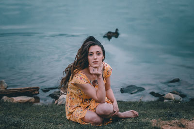 Portrait of young woman sitting on beach