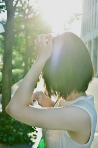 Side view of young woman in park