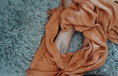 High angle view of woman resting on bed at home