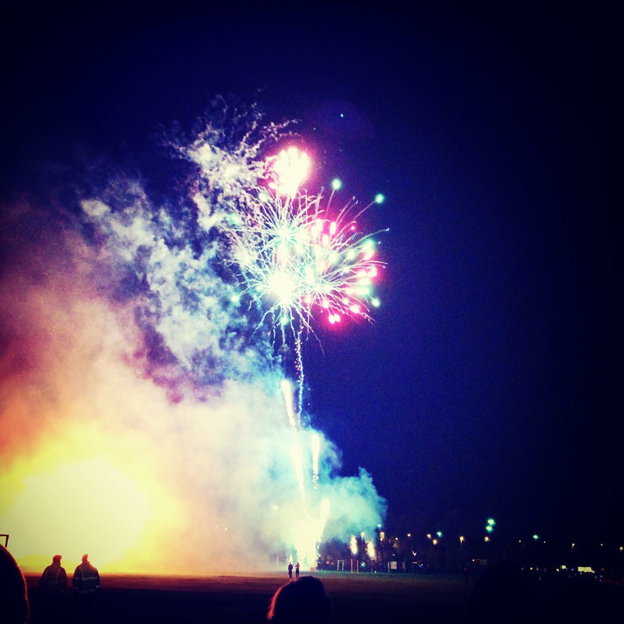 night, illuminated, firework display, exploding, long exposure, celebration, firework - man made object, glowing, firework, motion, sparks, sky, arts culture and entertainment, event, multi colored, blurred motion, low angle view, building exterior, entertainment, fire - natural phenomenon