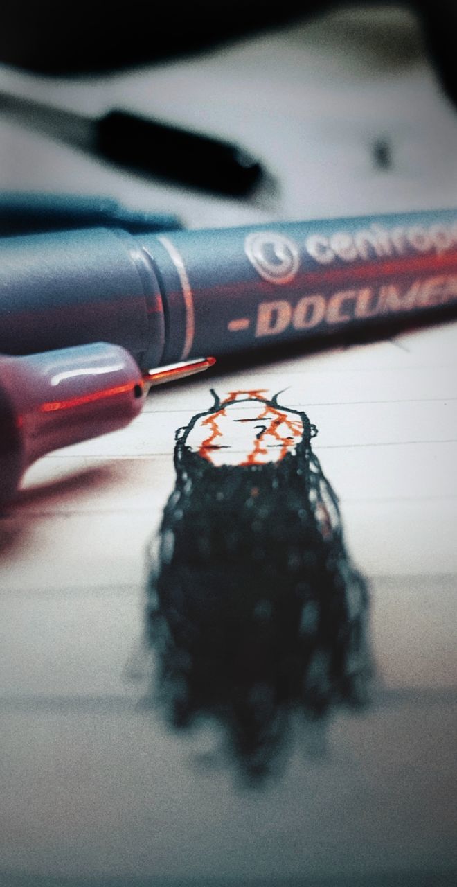 close-up, indoors, selective focus, human body part, human hand, table, technology, focus on foreground, still life, communication, body part, photography themes, art and craft, black color, red, activity, people, cable