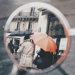 Man holding woman walking in city