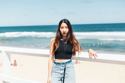 Young woman standing at beach