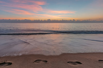 Scenic view of beach at sunset