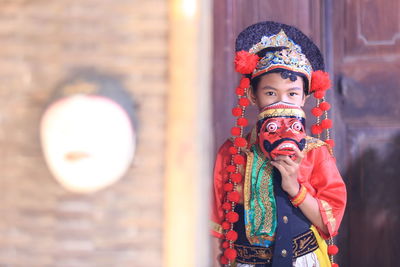 Traditional mask dancer with red costume