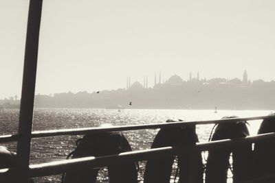 People in water against clear sky