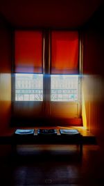 Empty chairs and table in illuminated room