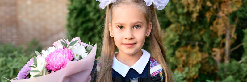 Portrait of smiling girl standing outdoors