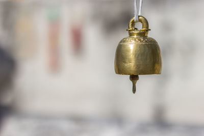 Close-up of golden bell hanging