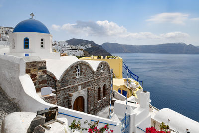 Panoramic view of sea and buildings against sky