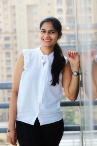 Portrait of a smiling young woman standing outdoors