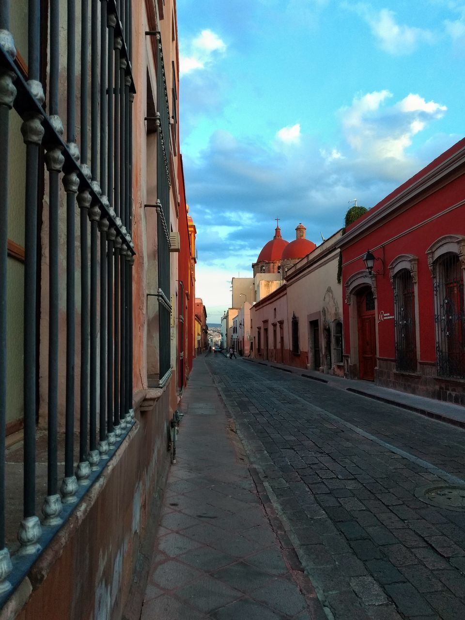 STREET AMIDST BUILDINGS AGAINST SKY