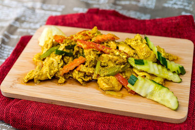 Close-up of seafood with vegetables on cutting board at table