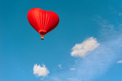 Low angle view of hot air balloon against blue sky