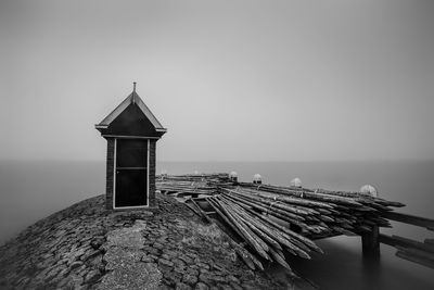 Lifeguard hut by sea against clear sky