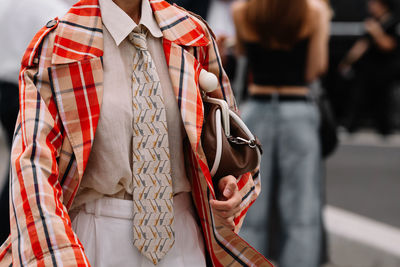 Midsection of woman standing in city