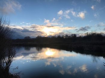 Scenic view of lake against sky at sunset