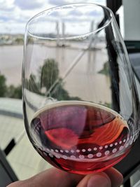 Some red wine in city of wine in bordeaux with the garonne behind. 