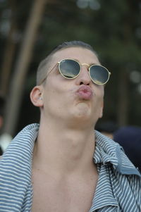 Close-up portrait of woman wearing sunglasses