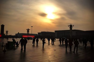 People in city at sunset