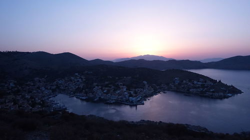 Scenic view of sea and mountains against clear sky