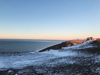 Scenic view of sea against clear sky during sunset