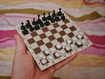 High angle view of person playing guitar on chess board