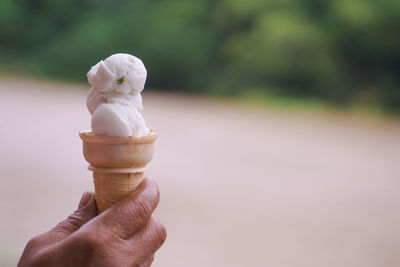 Close-up of hand holding ice cream