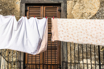 Close-up of clothes drying against building