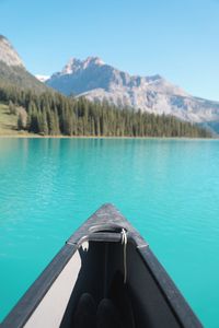 Swimming pool by lake against sky