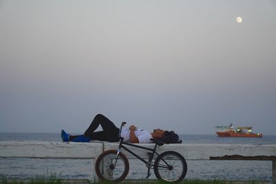 Bicycles on beach against clear sky